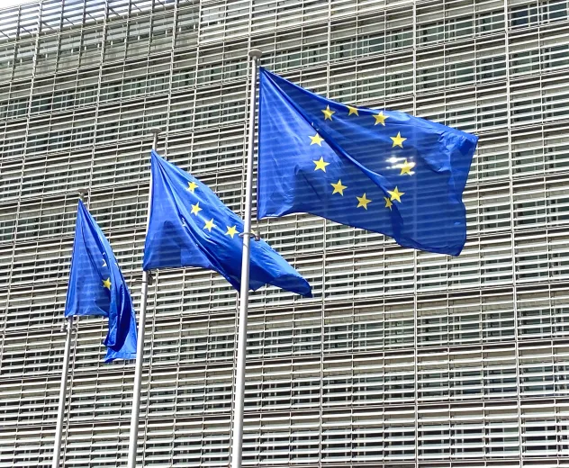European flags fly before modern building facade 2026 09 24 08 13 53 utc