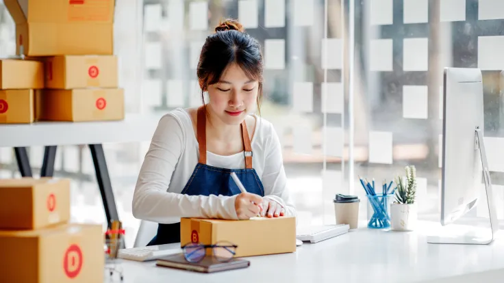 Cheerful woman fulfilling orders at desk in office 2026 09 21 19 55 38 utc
